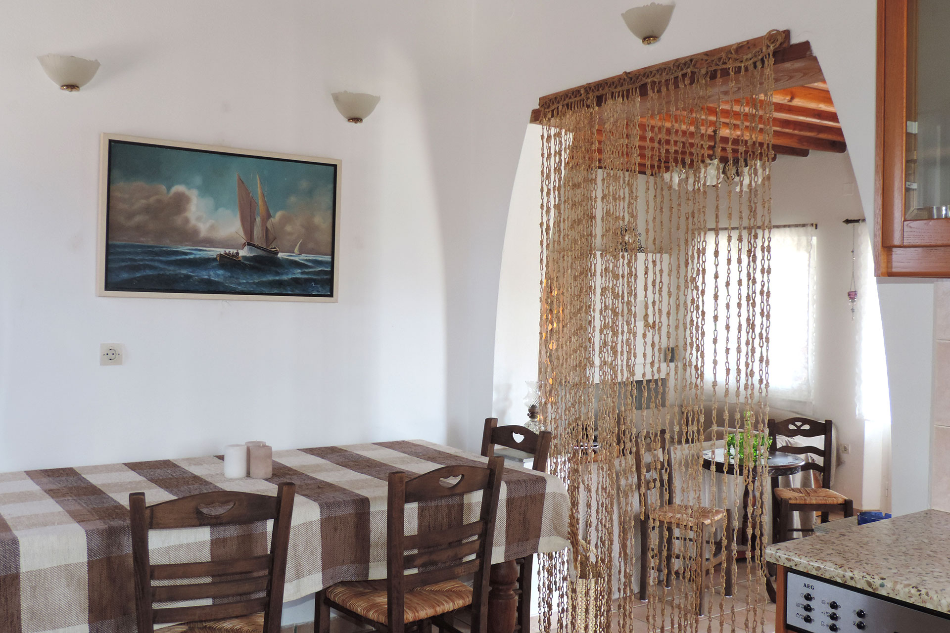 The dining area and the kitchen of Elia family house at Kavos